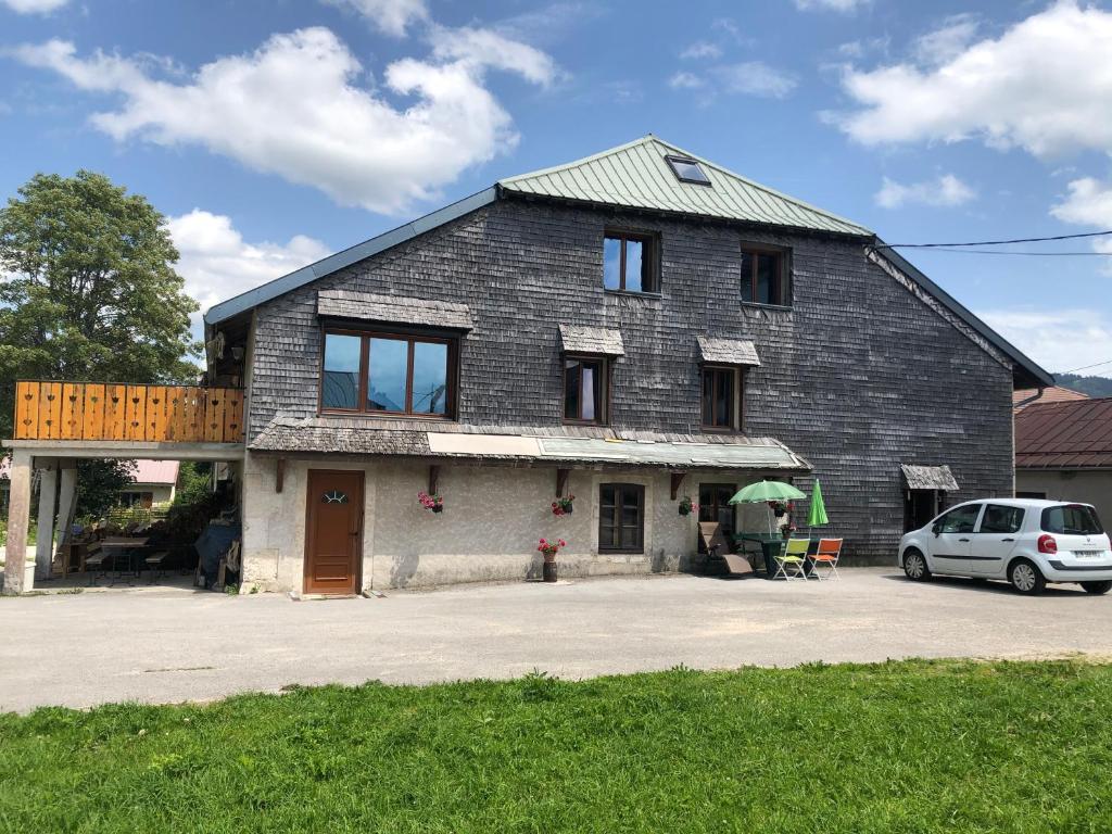 a house with a car parked in front of it at Gite des Rousses d'Amont - 15 personnes in Les Rousses