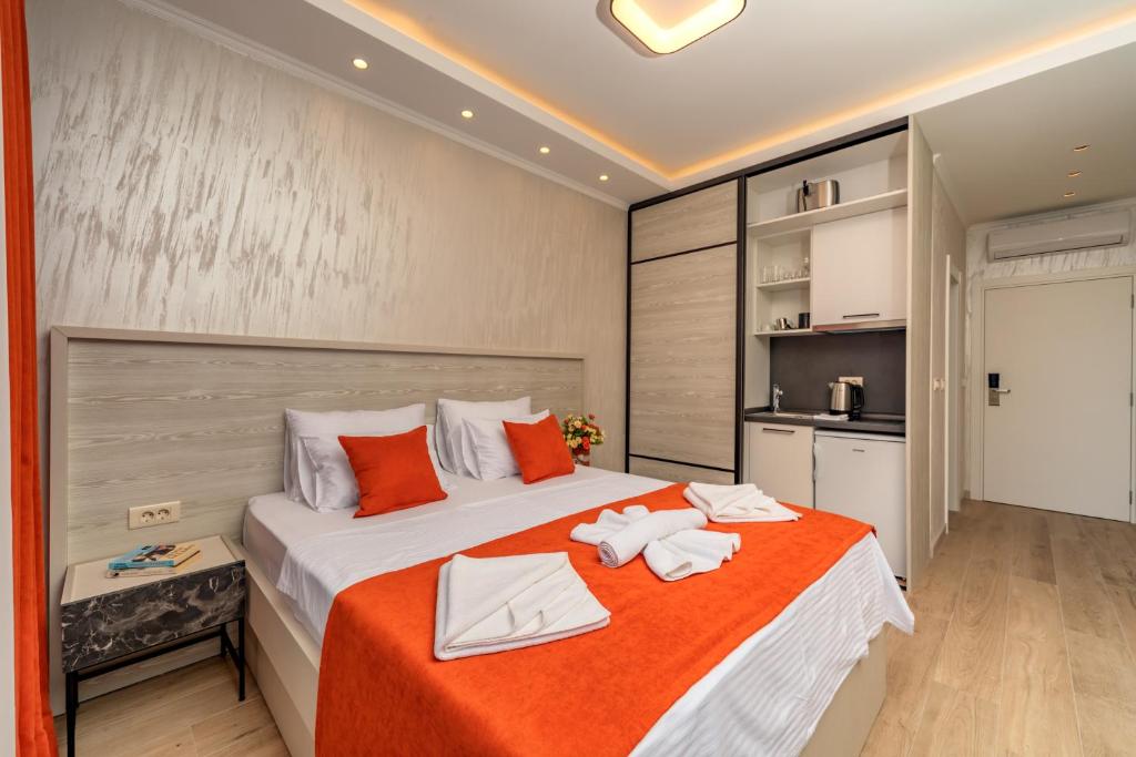 a bedroom with a large bed with towels on it at Luxury Apartments Queen in Petrovac na Moru