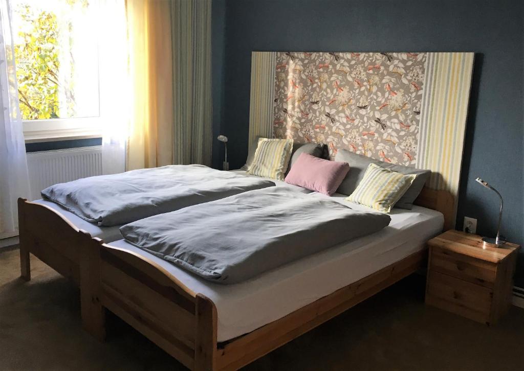 a bedroom with a large bed with a head board at Ferienwohnung Storchenblick in Zurow