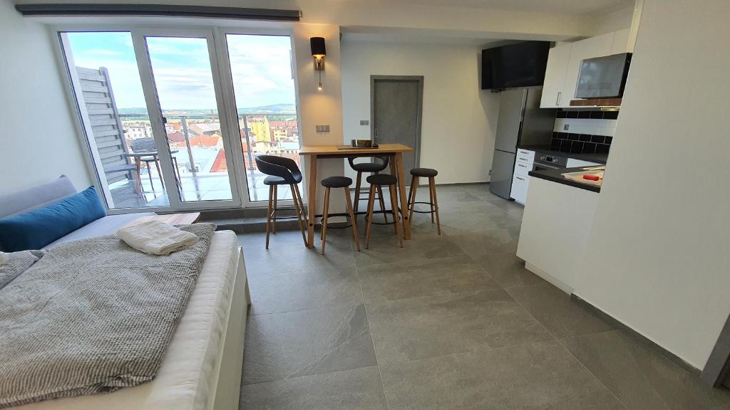 salon z kuchnią i stołem z krzesłami w obiekcie Magic Apartment centre Pilsen w Pilznie