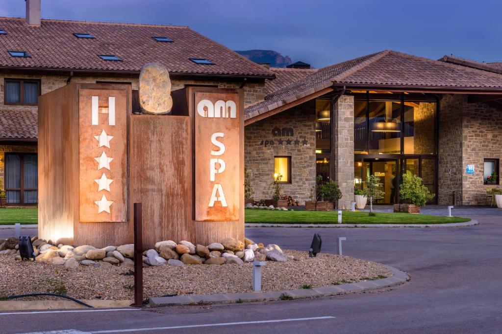a building with a sign in front of it at Hotel Spa Aguas de los Mallos in Murillo de Gállego