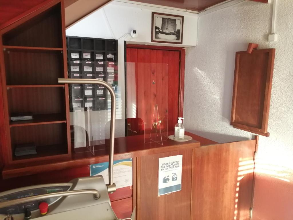 a kitchen with a counter and a sink in a room at Hostal Jaime I in Huesca