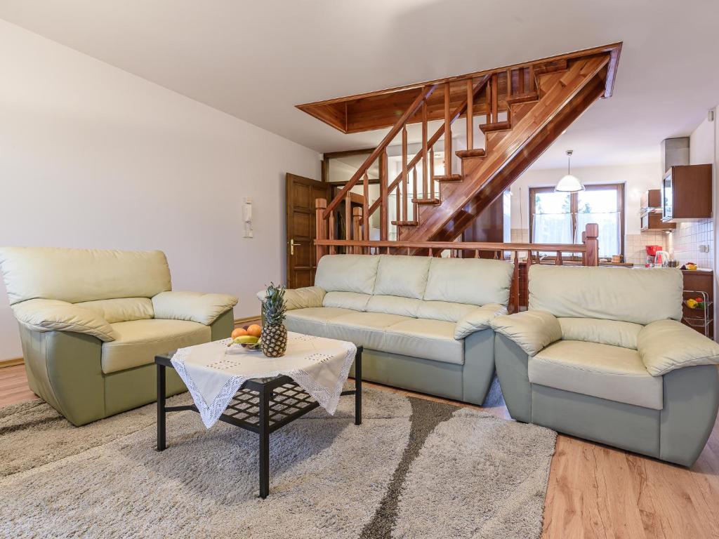 a living room with two couches and a table at VisitZakopane - Mountain Home Apartment in Zakopane