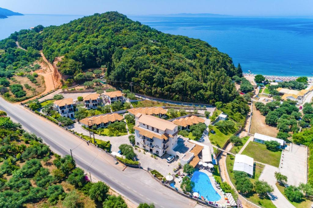 an aerial view of a villa with a resort and the ocean at MEGA AMMOS HOTEL in Syvota