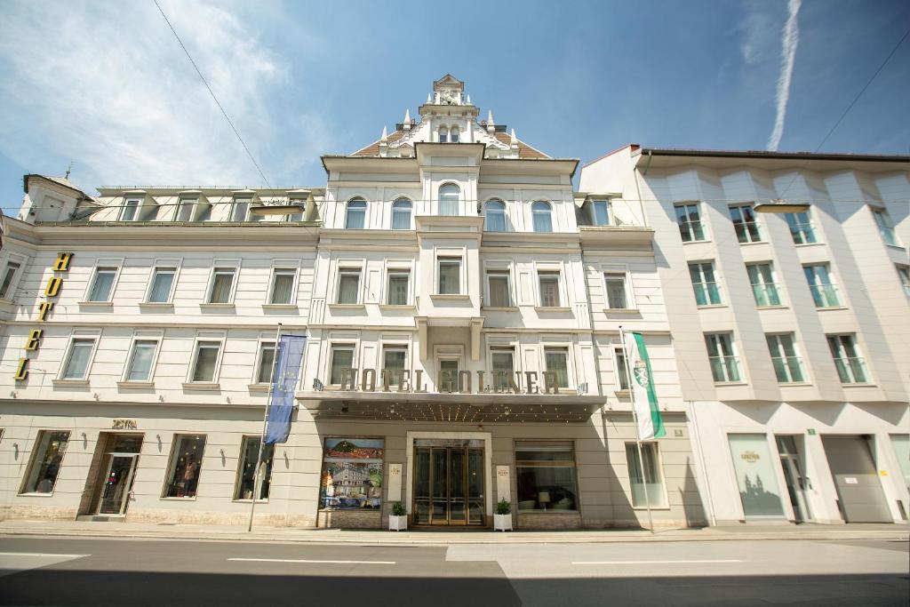 a large white building on the corner of a street at Hotel Gollner in Graz