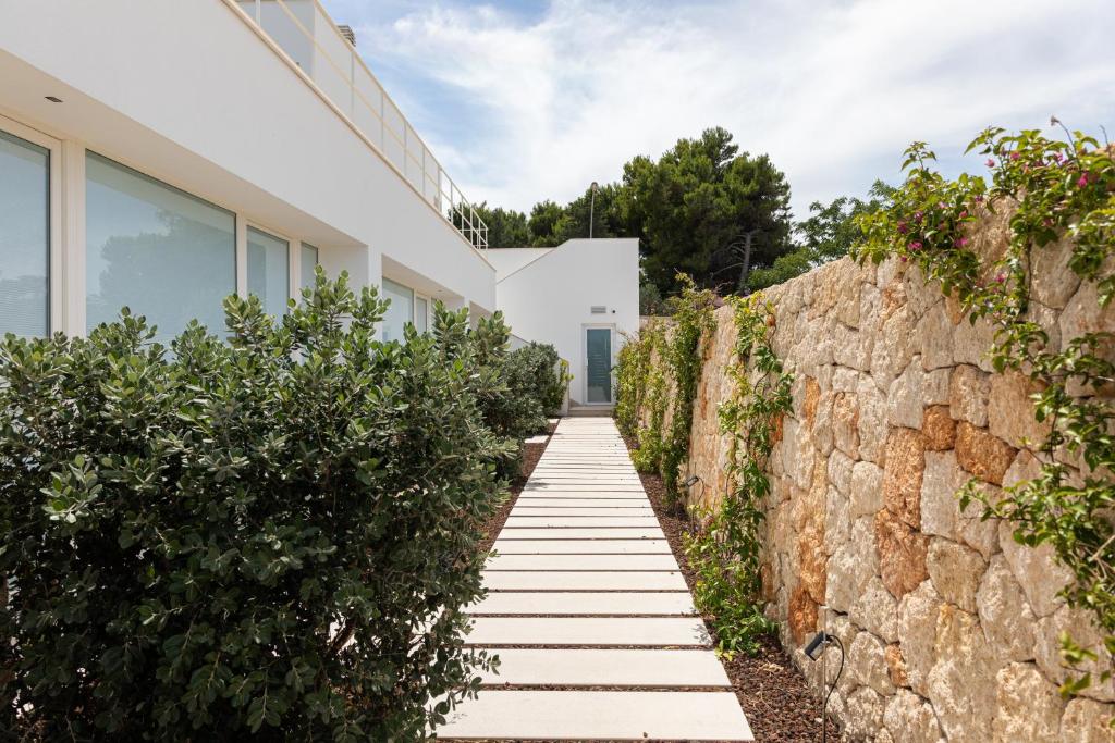 a stone wall next to a house at Santa Caterina - Dimora sul mare in Polignano a Mare