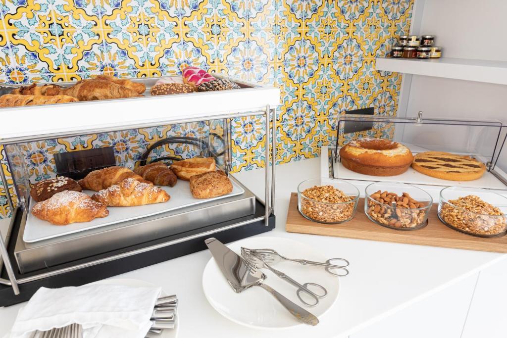 a bunch of pastries on shelves in a bakery at Santa Caterina - Dimora sul mare in Polignano a Mare