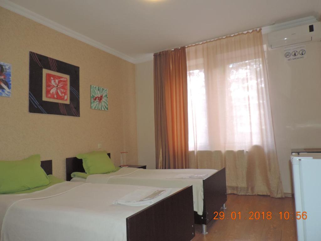 Letto o letti in una camera di Alma-Ata Hotel