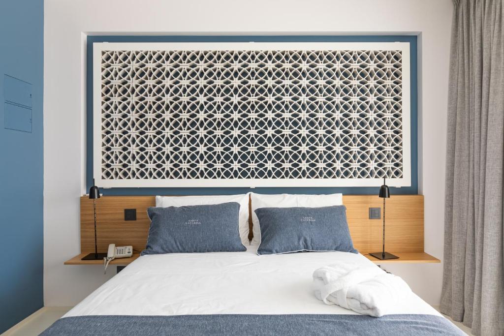 a bedroom with a bed with a large window at Santa Caterina - Dimora sul mare in Polignano a Mare