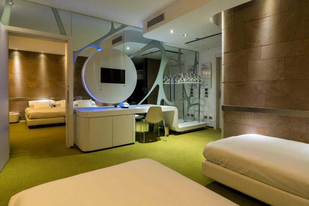 Postel nebo postele na pokoji v ubytování A Point Arezzo Park Hotel
