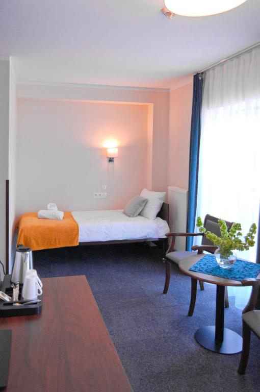 Posteľ alebo postele v izbe v ubytovaní Hotel Przy Solankach