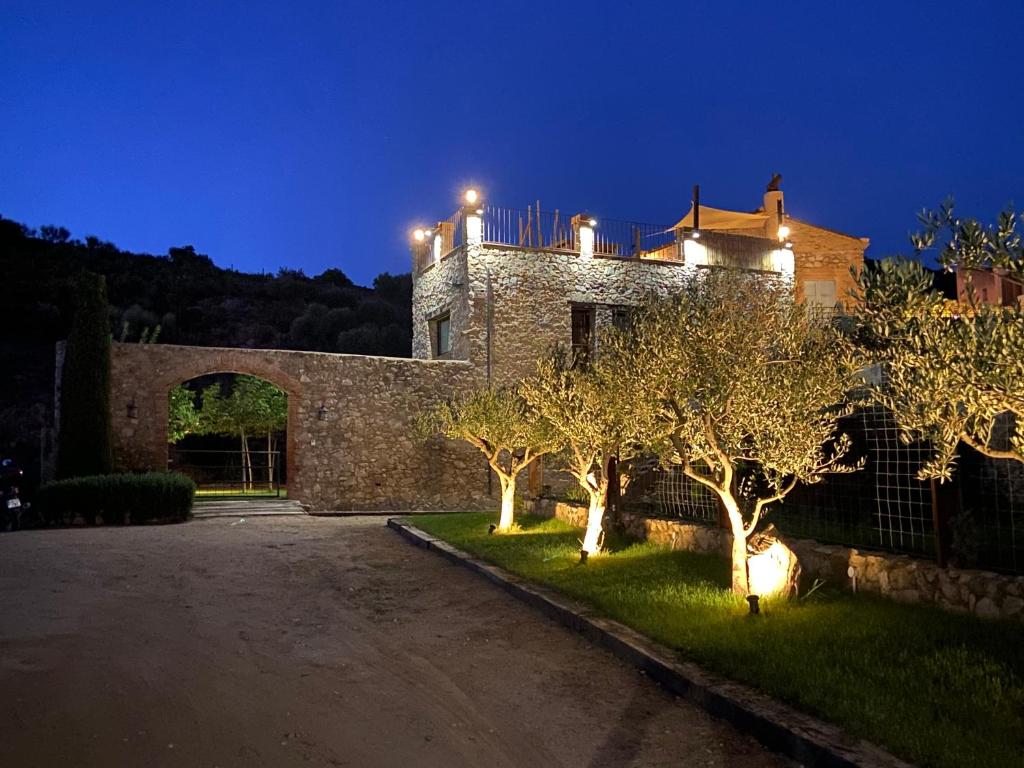 a house with lights on top of it at night at Can Massana in Pau