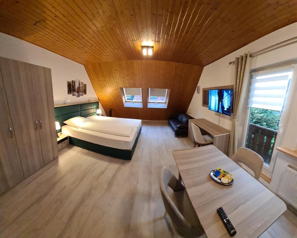 Habitación grande con cama y mesa. en Ferienwohnung-32609 W4, en Hüllhorst