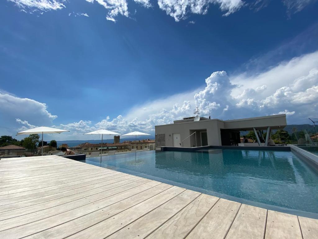 a swimming pool on top of a building at Solho Hotel in Bardolino