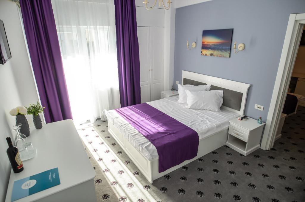 Postel nebo postele na pokoji v ubytování Hotel Tadora