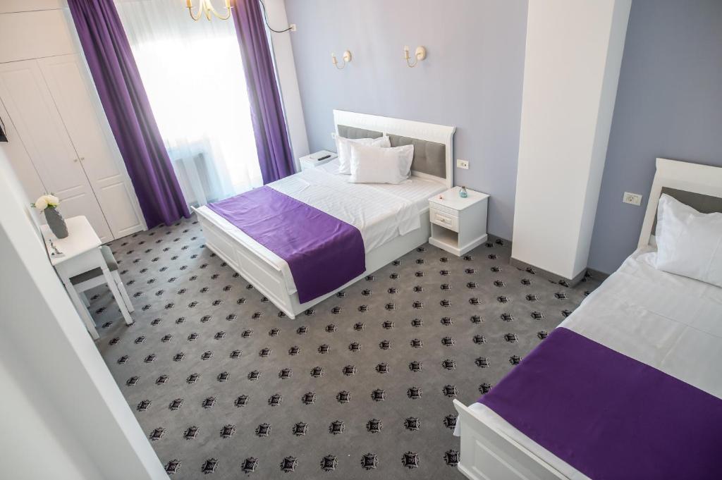 Postel nebo postele na pokoji v ubytování Hotel Tadora