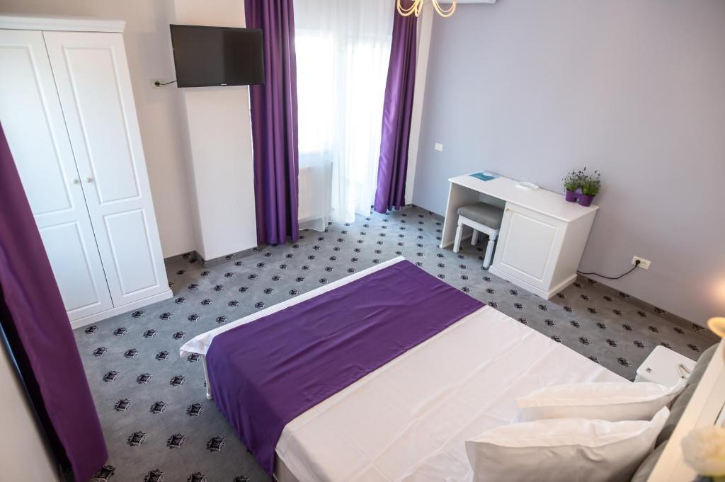 Postel nebo postele na pokoji v ubytování Hotel Tadora