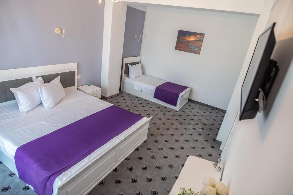 Postel nebo postele na pokoji v ubytování Hotel Tadora