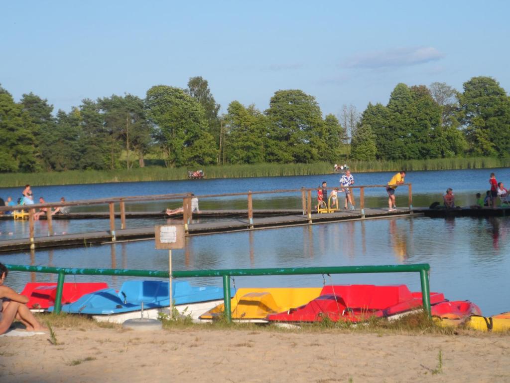 a group of people on a dock in a lake at Leśna Ryba in Jedlanka Stara