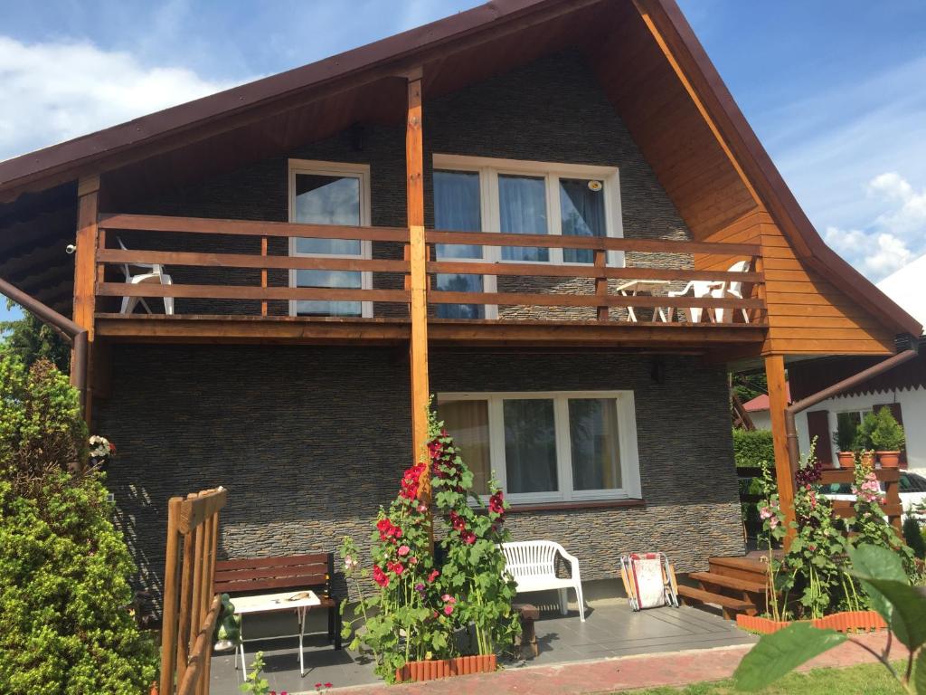 a house with a deck and a balcony at A&R Brzozowa 5 in Rowy