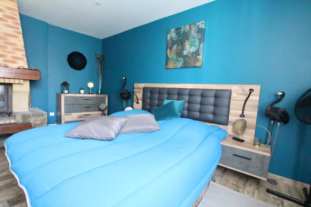 - une chambre bleue avec un grand lit aux murs bleus dans l'établissement Colmar City Center - Apartment Duplex MARIGNY - BookingAlsace, à Colmar