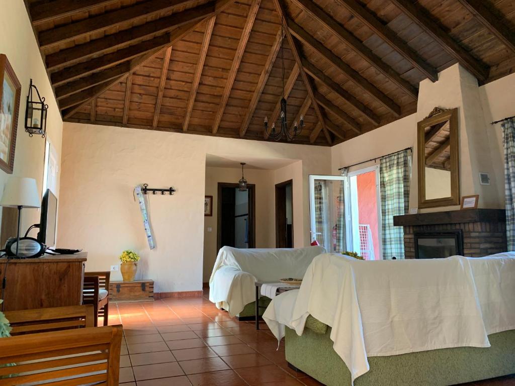 a living room with two beds and a fireplace at Villas Las Cercas in El Paso