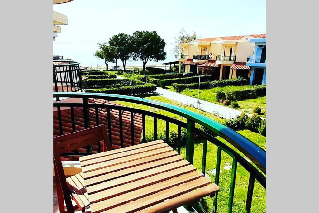 a wooden bench sitting on top of a balcony at Tetis seafront maizonette in Nikiti