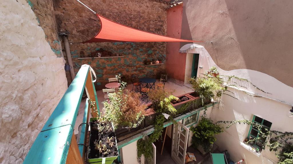 an overhead view of a balcony with plants and a building at Maison Mômes in Bize-Minervois