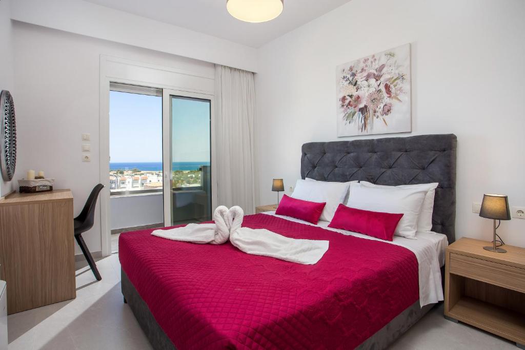 a bedroom with a large bed with a red blanket at Kalathos Sea View House in Kalathos