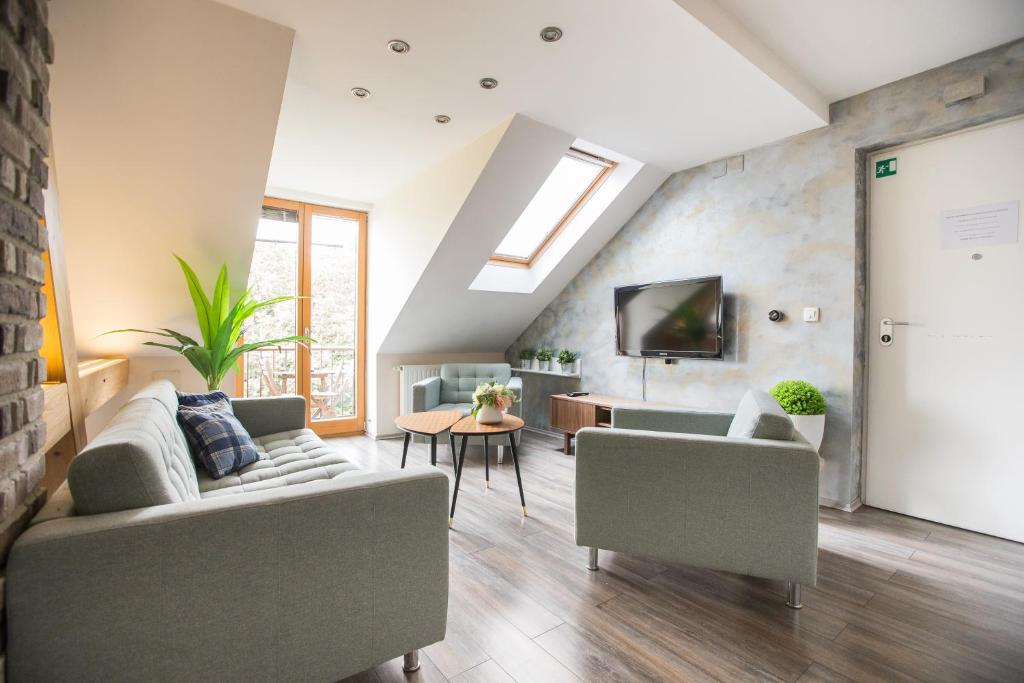 a living room with two couches and a tv at Apartment Zagreb Deluxe in Zagreb