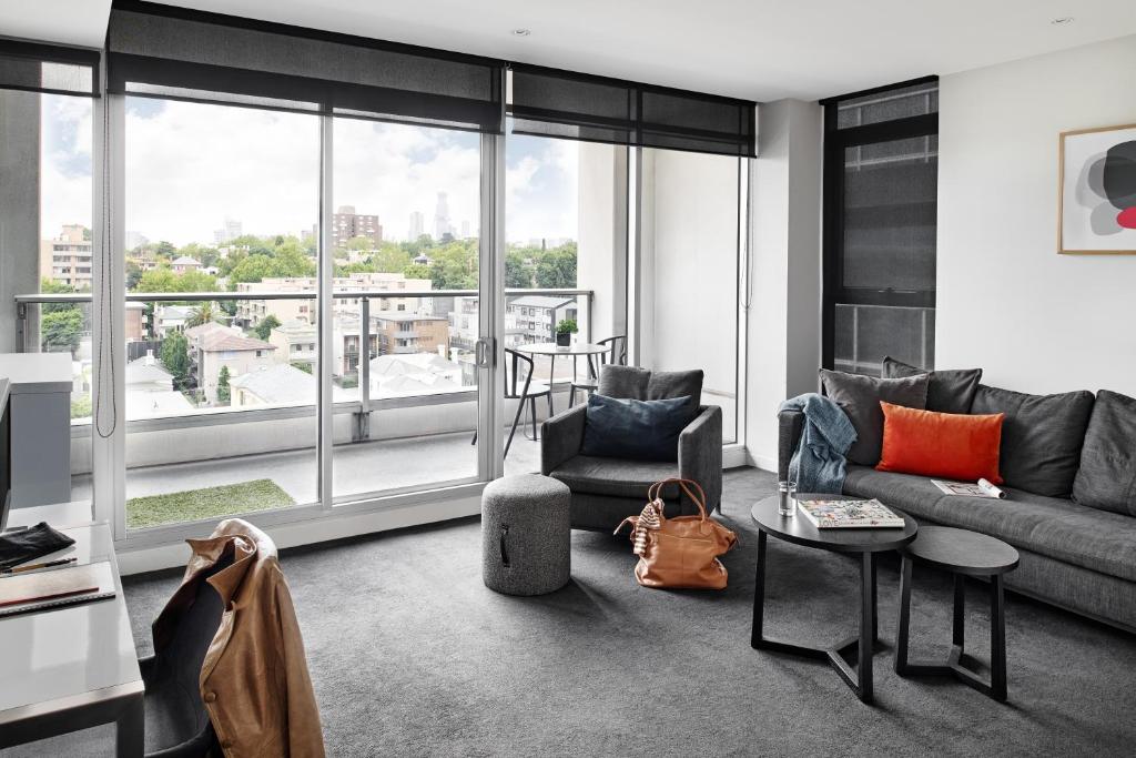 a living room filled with furniture and a window at Punthill South Yarra Grand in Melbourne