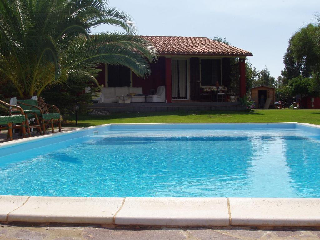 a large blue swimming pool in front of a house at Villa Franca in Pula