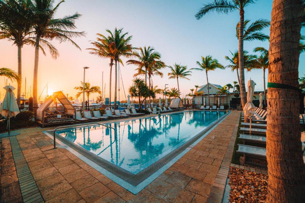 a pool at a resort with palm trees at The Perry Hotel & Marina Key West in Key West