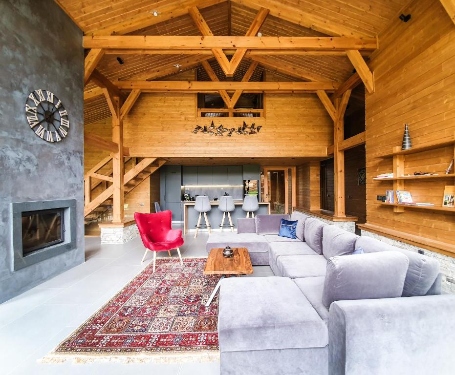 a living room with a couch and a fireplace at Mountain Hawk Park in Razlog