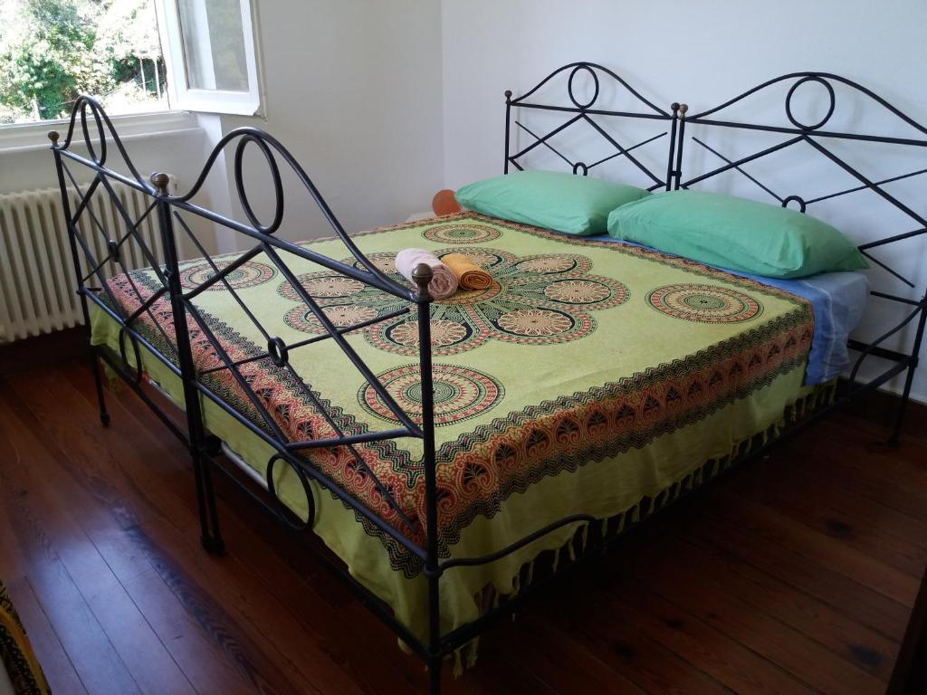 a bedroom with a bed with a metal frame at Trekking in paradise B&B in Santa Margherita Ligure