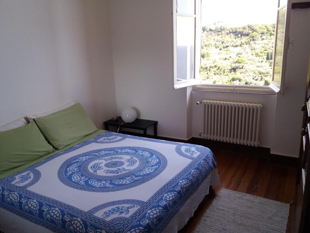 a bedroom with a bed and a window at Trekking in paradise B&B in Santa Margherita Ligure