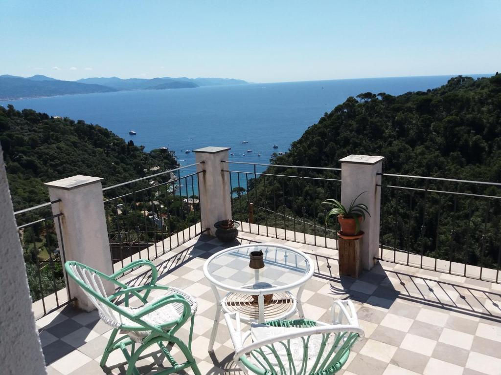 a balcony with a table and chairs and the ocean at Trekking in paradise B&B in Santa Margherita Ligure