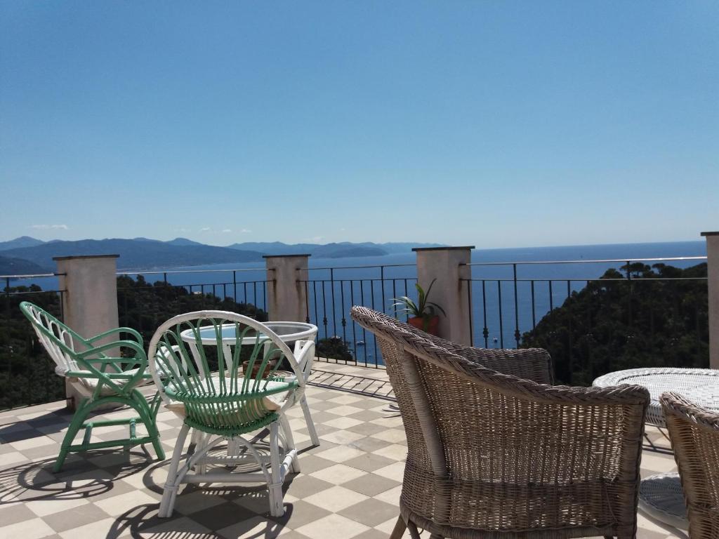 a group of chairs and tables on a patio at Trekking in paradise B&B in Santa Margherita Ligure