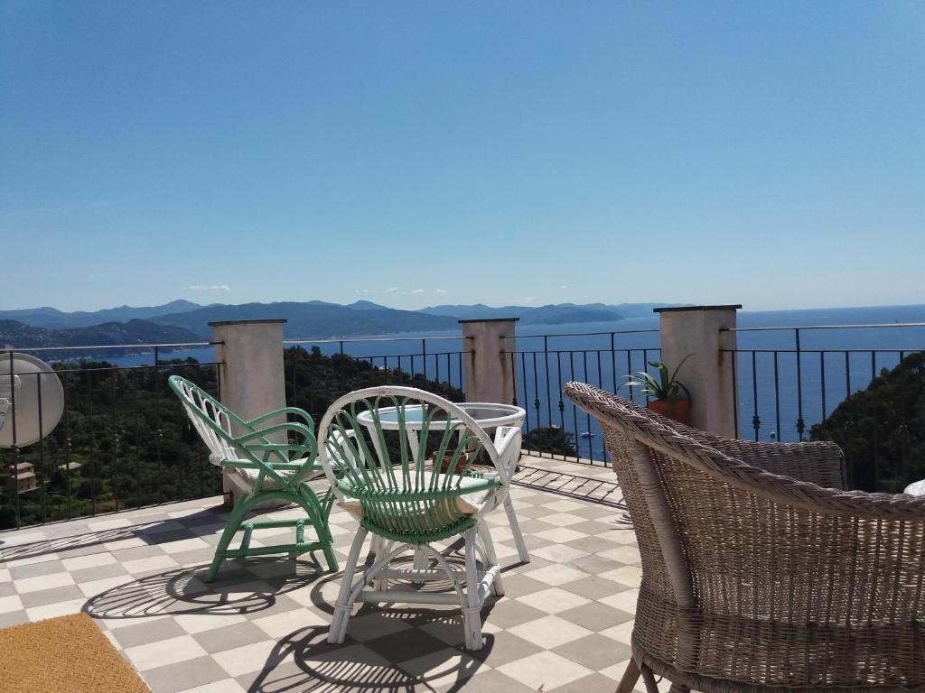 a patio with chairs and a view of the ocean at Trekking in paradise B&B in Santa Margherita Ligure