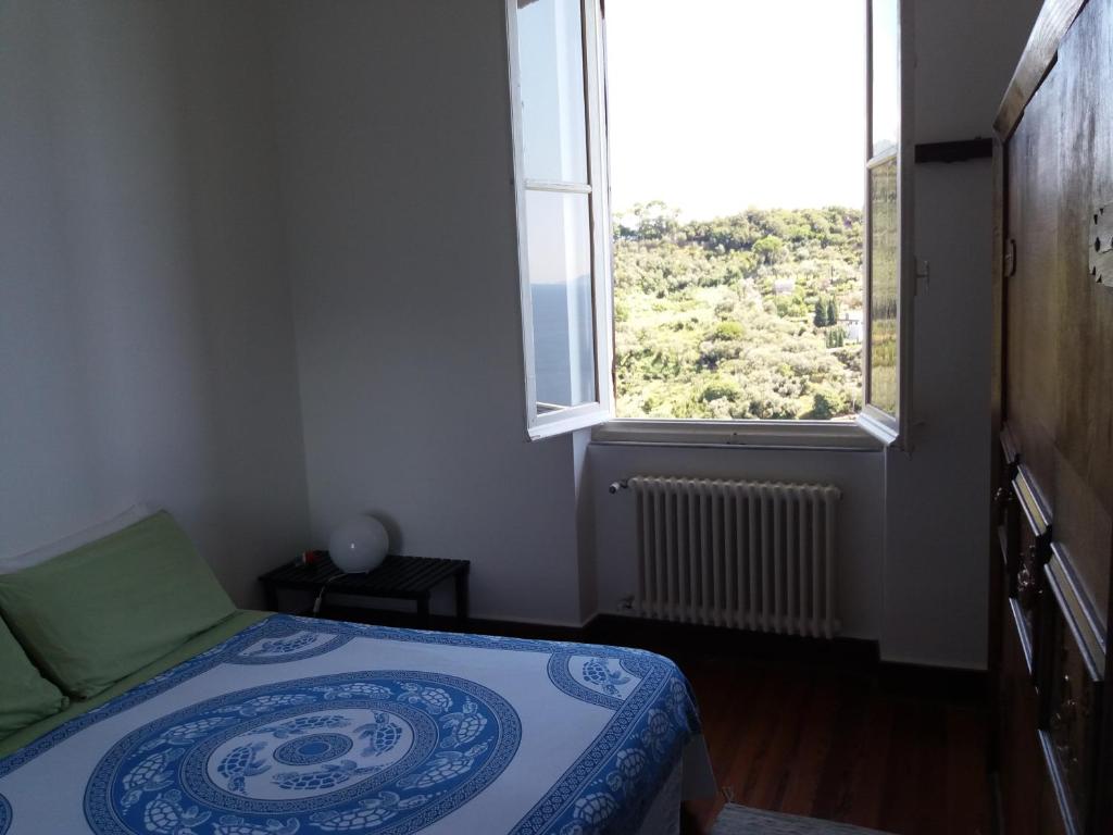 a small bedroom with a bed and a window at Trekking in paradise B&B in Santa Margherita Ligure