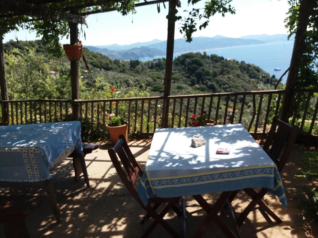 a table and chairs on a balcony with a view of the mountains at Trekking in paradise B&B in Santa Margherita Ligure