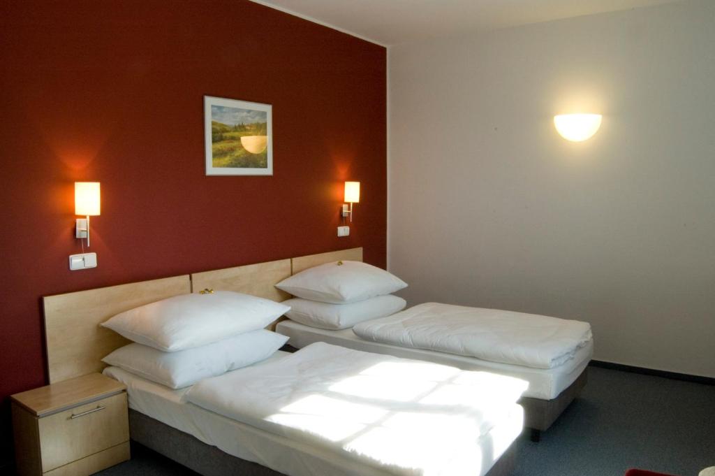 Postel nebo postele na pokoji v ubytování Hotel Chvalská Tvrz