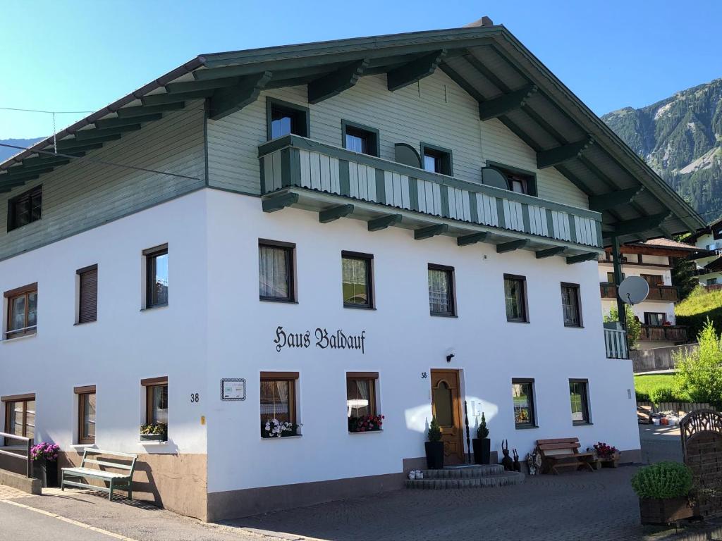 a large white building with a gambrel roof at Gästehaus Baldauf in Berwang
