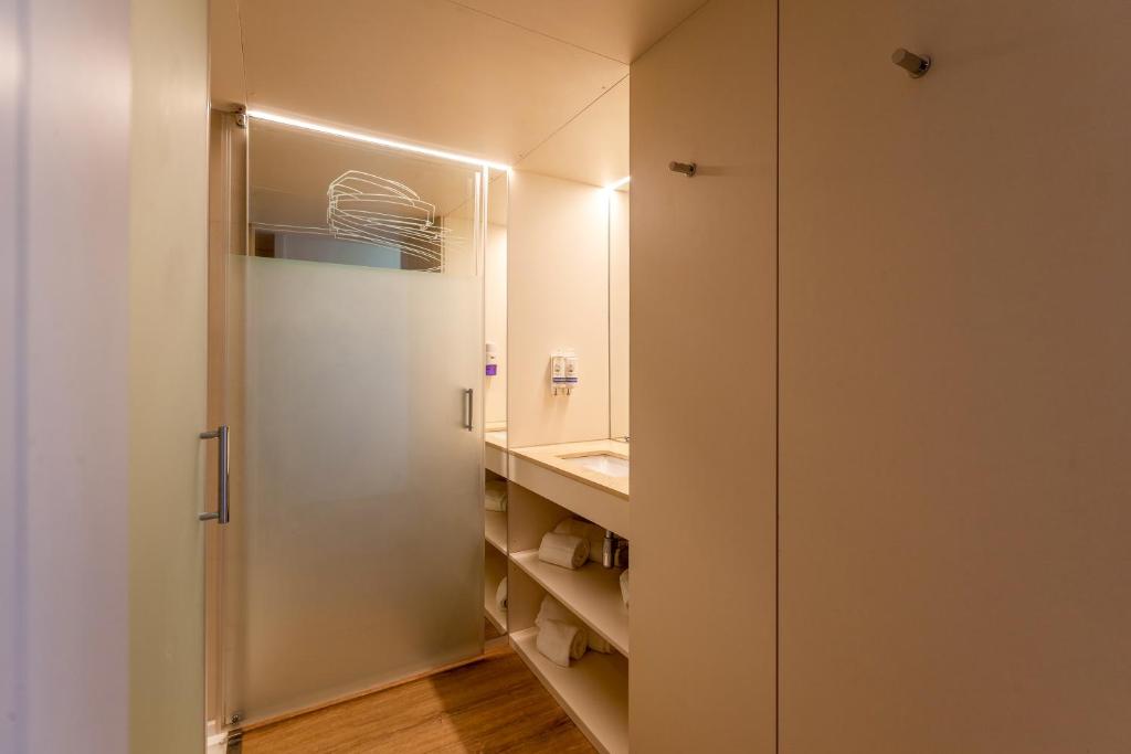 a bathroom with a shower and a sink at Sea Porto Hotel in Matosinhos