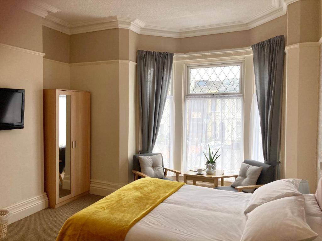 a hotel room with a bed and a window at The Copplehouse in Southport