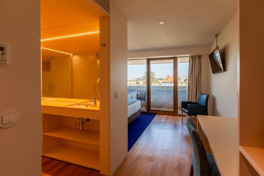 a hotel room with a view of a bathroom at Sea Porto Hotel in Matosinhos