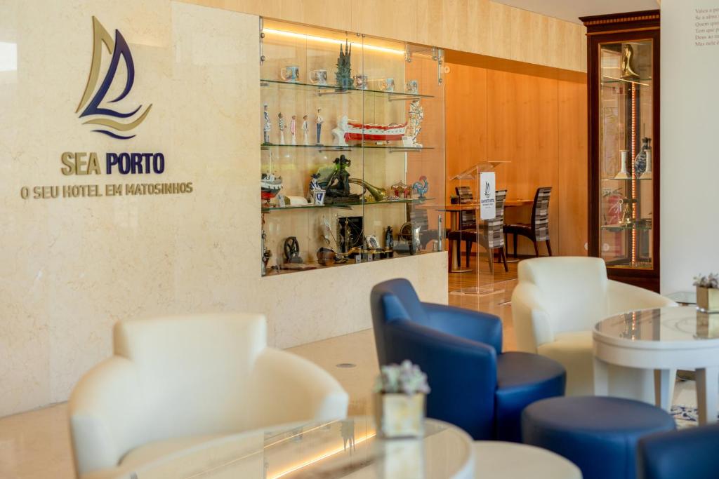 a restaurant with chairs and tables and a sign on the wall at Sea Porto Hotel in Matosinhos