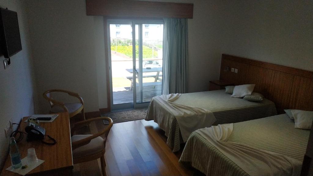 Postel nebo postele na pokoji v ubytování Hotel Comodoro
