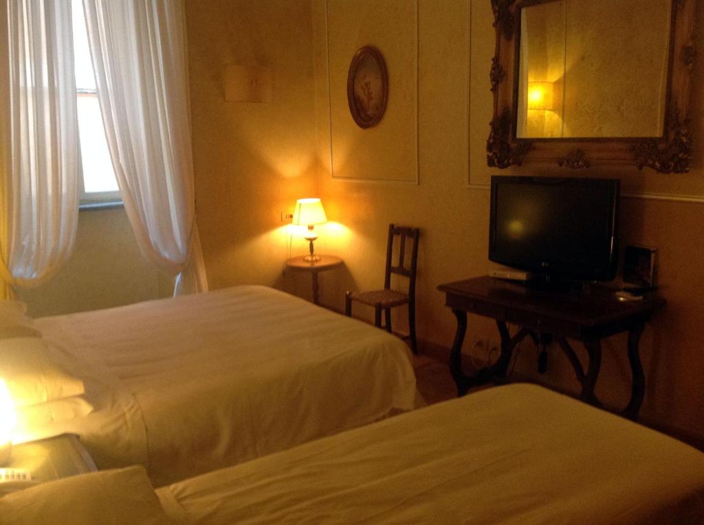 Postel nebo postele na pokoji v ubytování Hotel Fontana