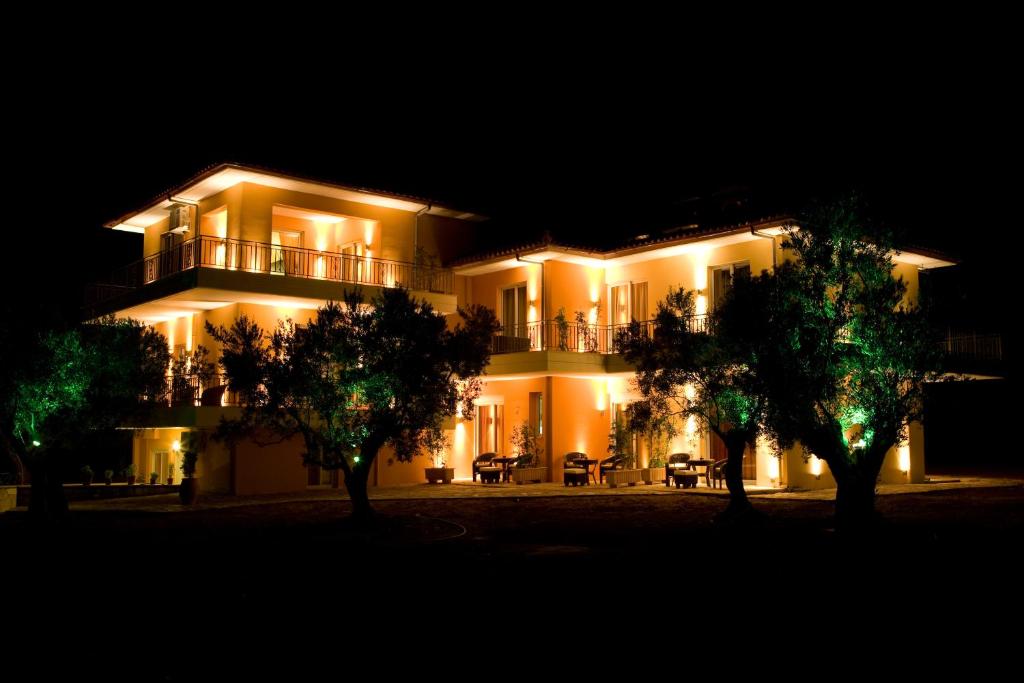 a lit up building with trees in front of it at Agroktima Elia in Nafplio